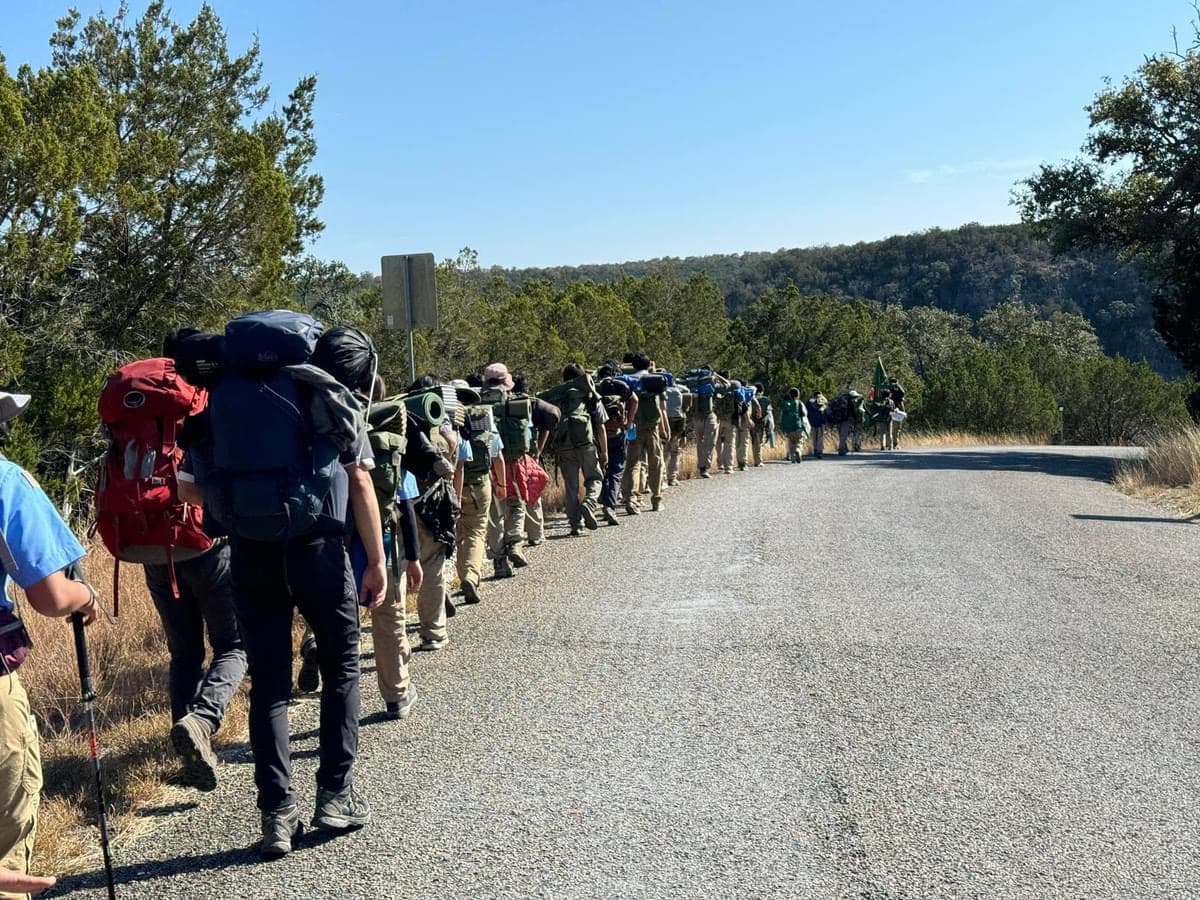 A line of scouts with packs on the trail